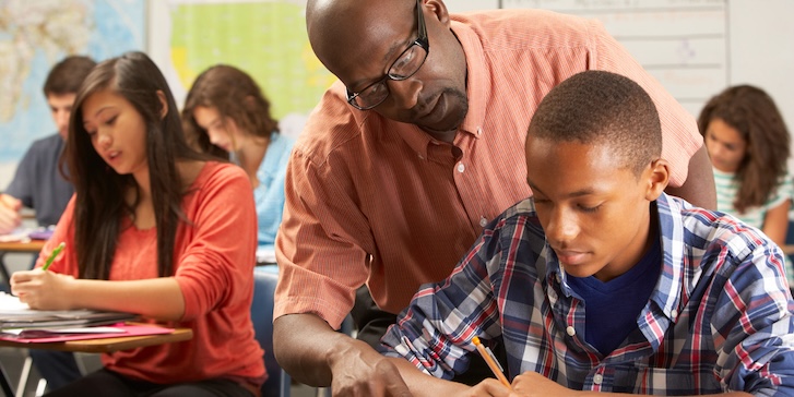 A teacher helping a student with classwork A teacher helping a student with classwork